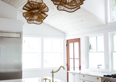 Kitchen island with woven pendant lights and marble counter