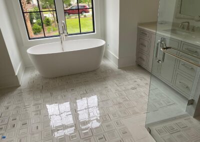Freestanding soaking tub beside a tiled walk-in shower