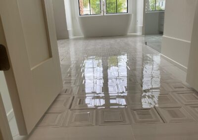 Glossy tile floor running through a hallway after installation