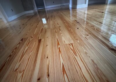 Restored heart pine floor running through a bright room