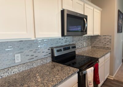 Kitchen with granite counters and wood flooring underfoot