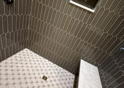 Hexagon tile shower wall with a marble-look floor