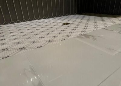 Patterned tile floor with a marble border, freshly laid