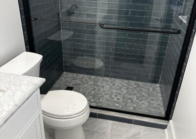 Frameless glass shower over marble-look floor tile